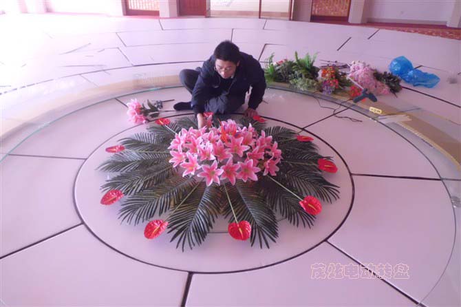 小伙在為電動(dòng)餐桌玻璃轉(zhuǎn)盤插花